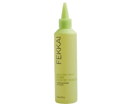 A light yellow-green squeeze bottle of Fekkai Apple Cider Detox Rinse on a solid white background.