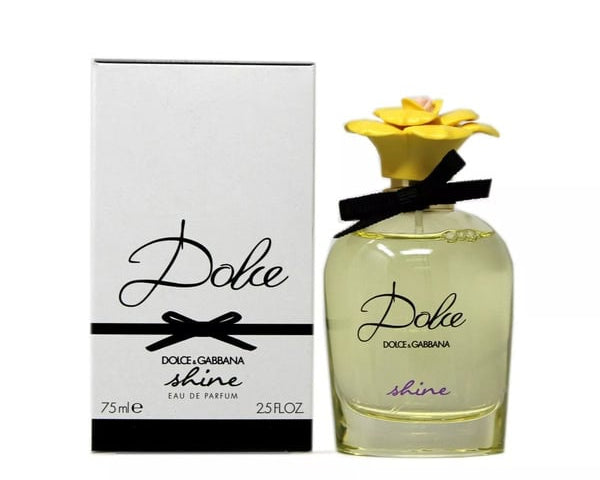 Dolce Gabbana Shine Eau de Parfum 75ml bottle with its white packaging box, featuring a yellow flower cap and black ribbon on a white background.